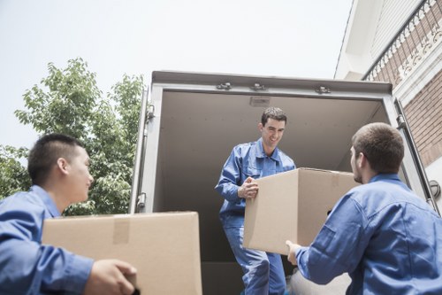 House movers carrying packed boxes and furniture